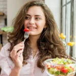 Woman eating a bowl of salad