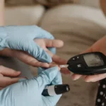 Person checking diabetes with the use of glucose monitor