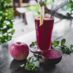 apple, juice and beetroot on table.