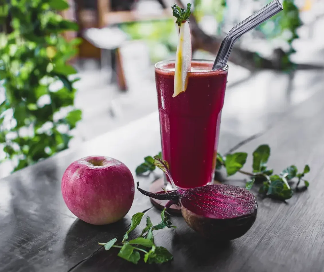 apple, juice and beetroot on table.