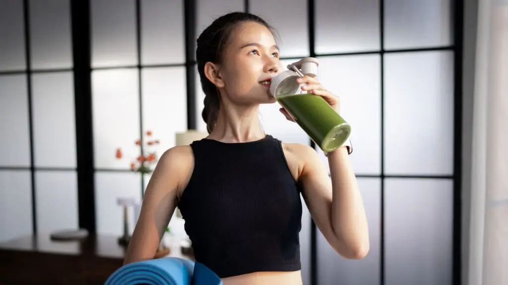 Woman drinking juice to detoxify liver