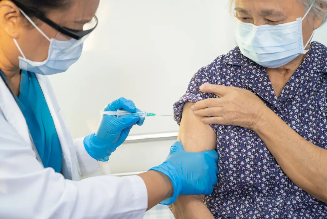 Old Woman taking covid-19 vaccine